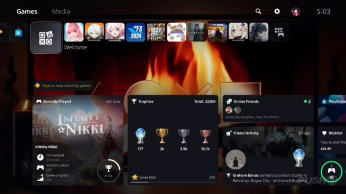 Pantalla de inicio de PS5 con fondo animado de chimenea y trofeos